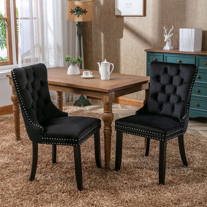 Tufted velvet dining chairs with nailhead trim, black upholstery, set of 2 around a wooden table on Tampa Home & Garden Store