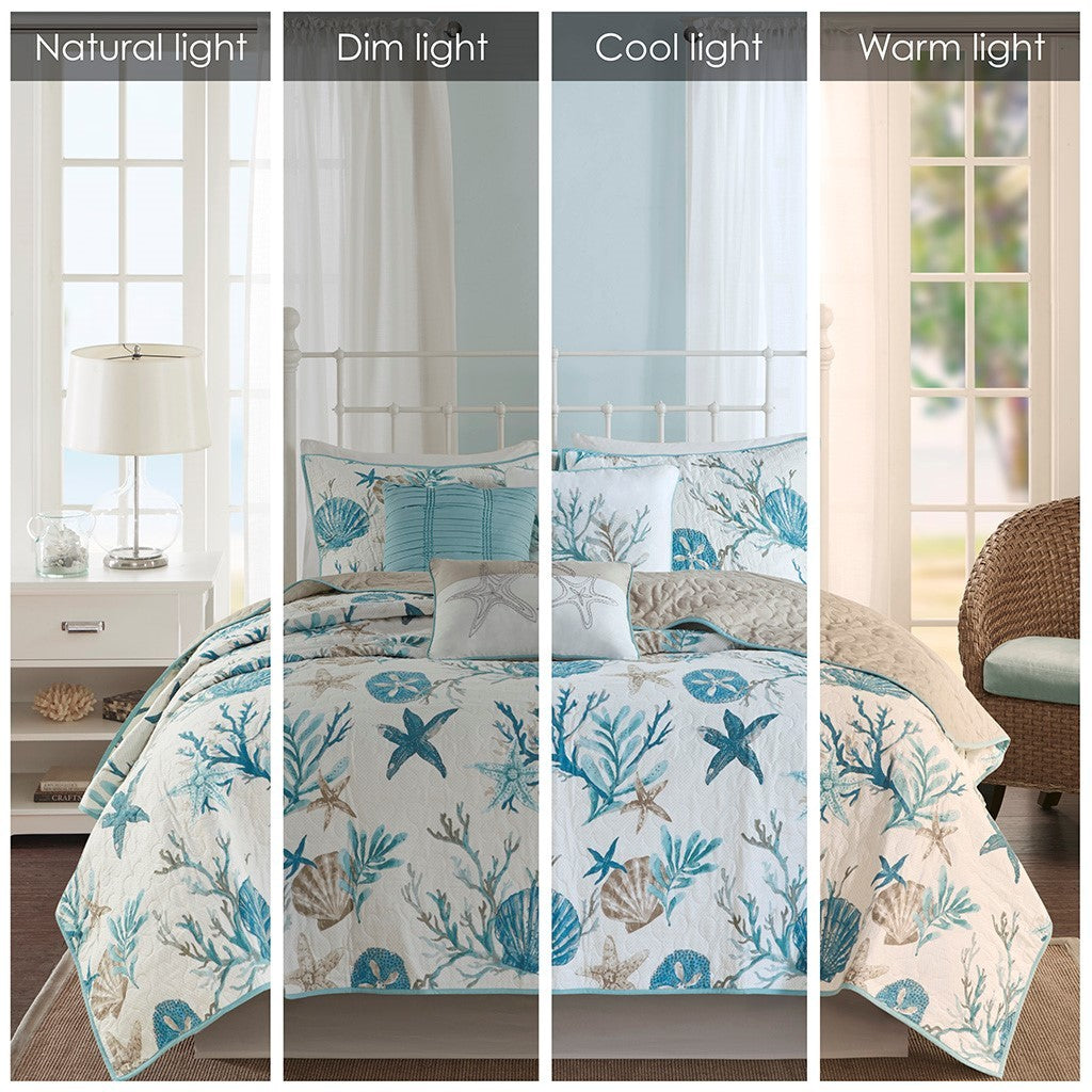 Aqua cotton sateen quilt set with matching coastal throw pillows on white metal bed on Tampa Home & Garden Store