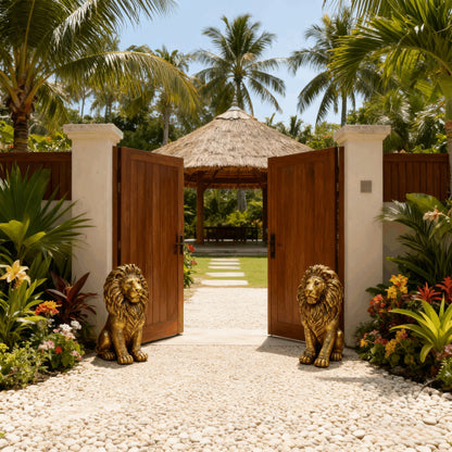 Pair of 24-inch lion statues, resin outdoor sculptures in bronze finish guarding a wooden gate on Tampa Home & Garden Store