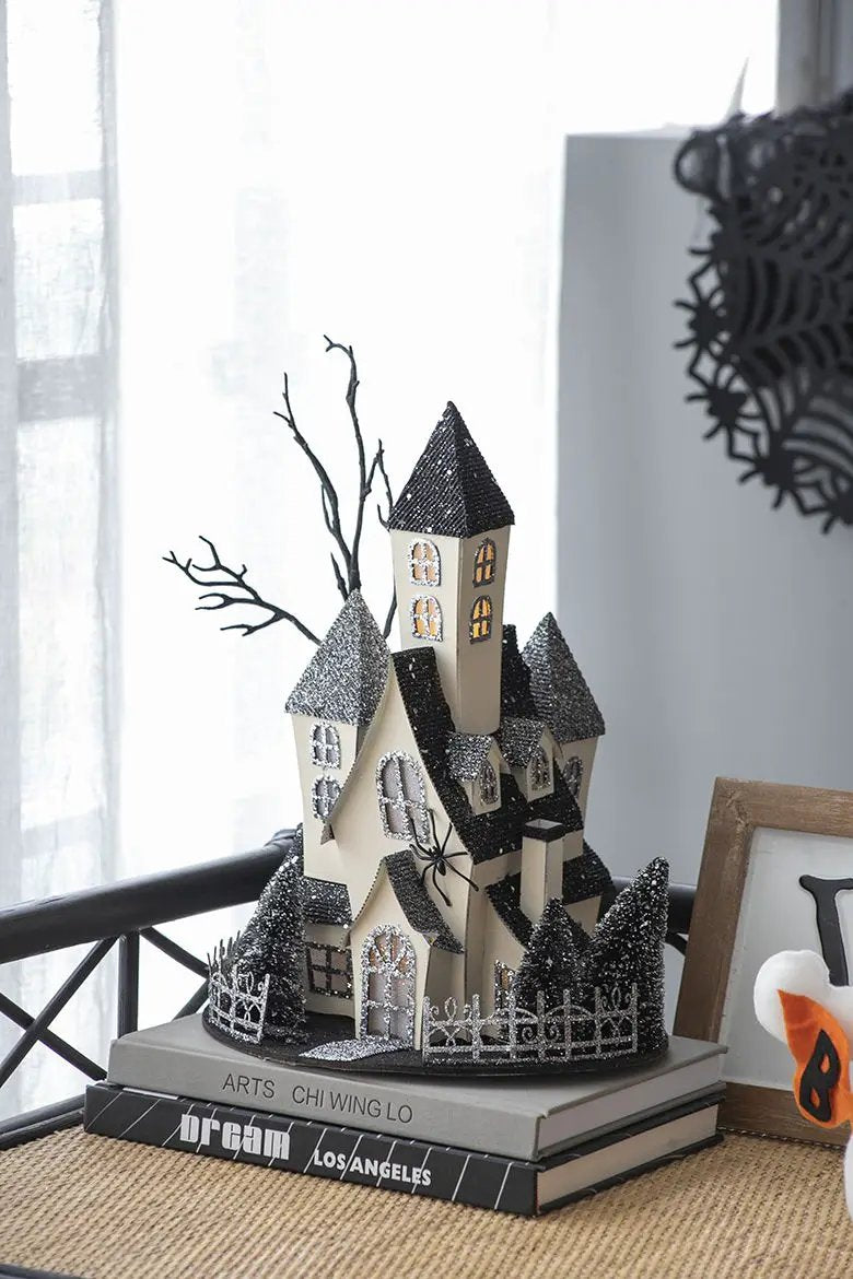 Cardboard lighted haunted house tabletop sculpture, beige, glittery black roofs on Tampa Home & Garden Store