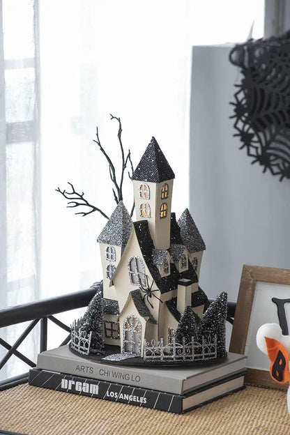 Cardboard lighted haunted house tabletop sculpture, beige, glittery black roofs on Tampa Home & Garden Store