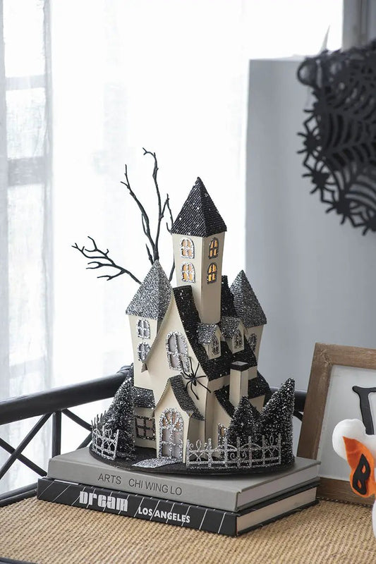 Cardboard lighted haunted house tabletop sculpture, beige, glittery black roofs on Tampa Home & Garden Store
