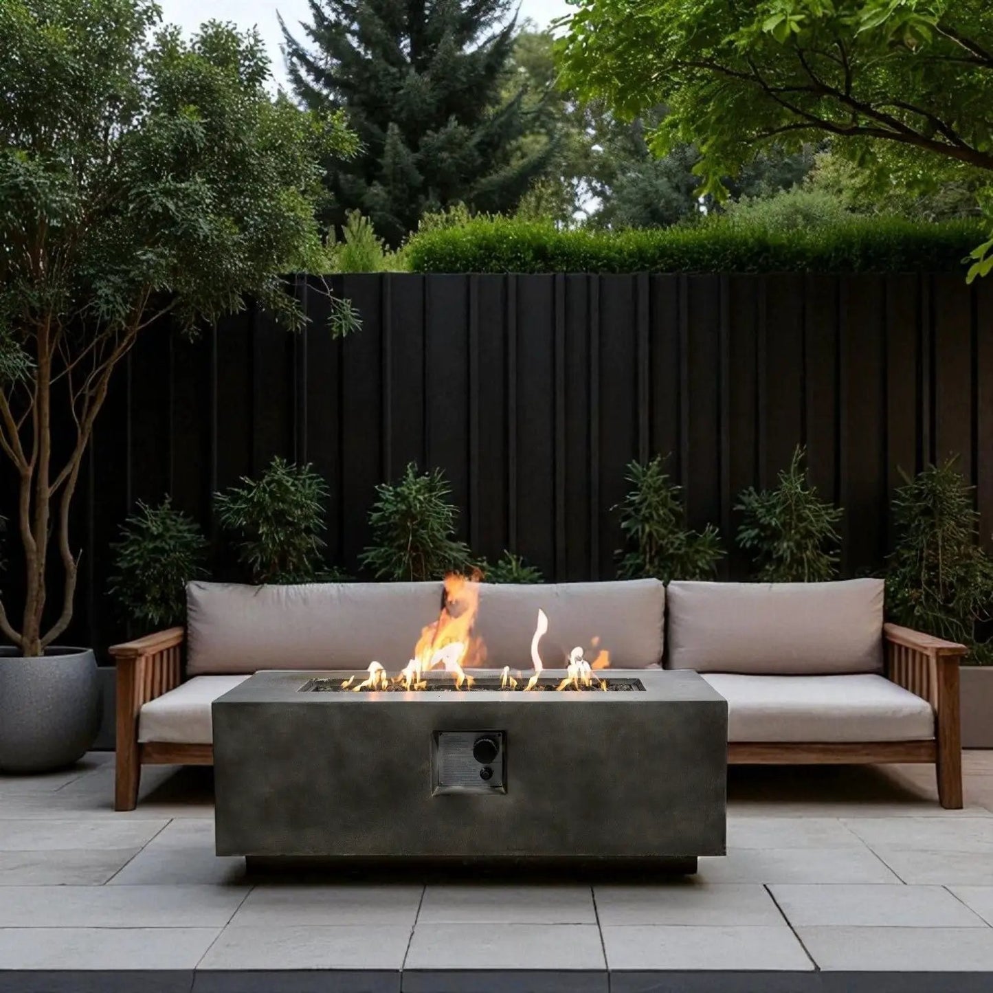 Fire Pit Table by Unique Piece Furniture in dark gray concrete with flames, outdoor sofa on Tampa Home & Garden Store