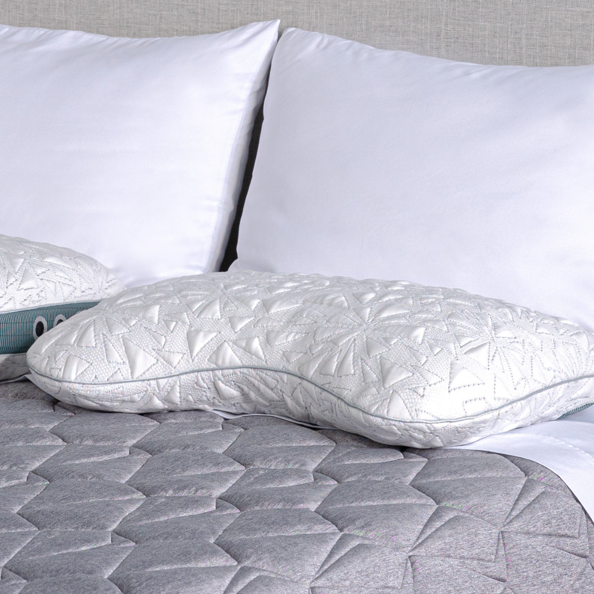 Storm Cuddle Curve backrest pillow white quilted geometric stitching on gray quilted bed on Tampa Home & Garden Store