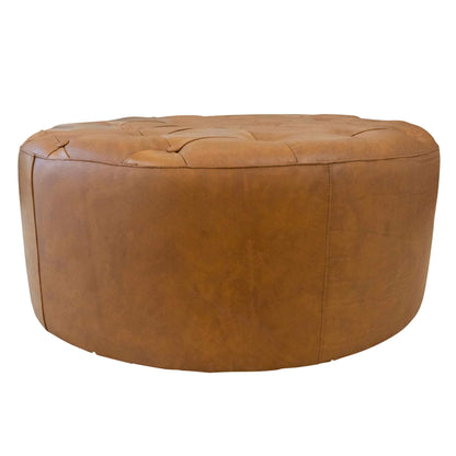 Light tan leather ottoman with tufted top and rounded sides on Tampa Home & Garden Store