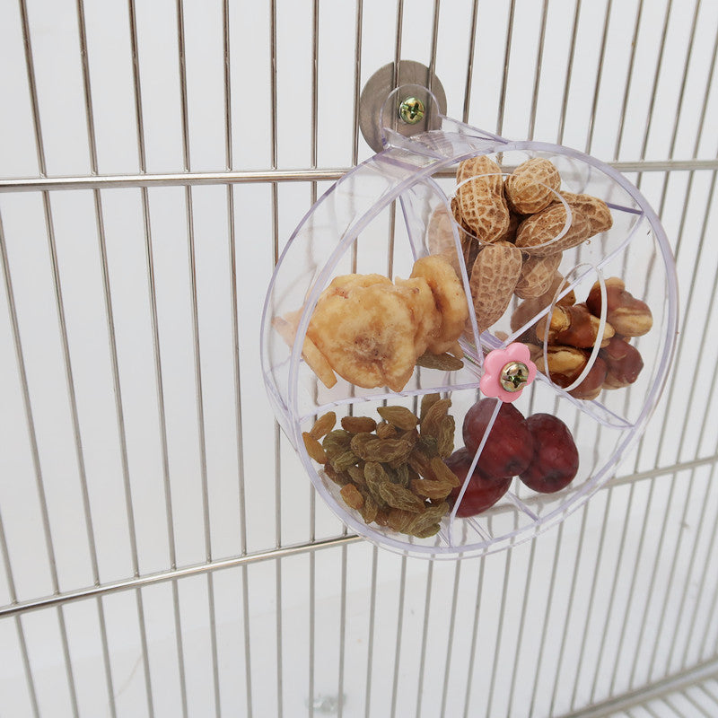 Parrot foraging wind wheel acrylic circle with seeds mounted to cage on Tampa Home & Garden Store