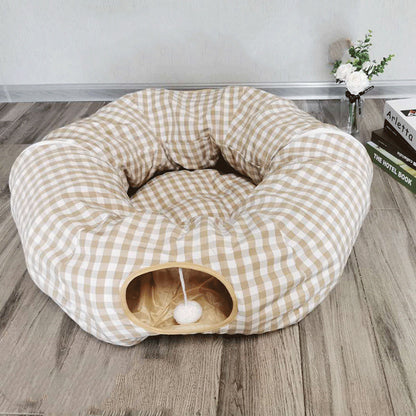 Cat tunnel sleeping nest in beige checkered fabric with circular entrance and hanging pom-pom toy on Tampa Home & Garden Store