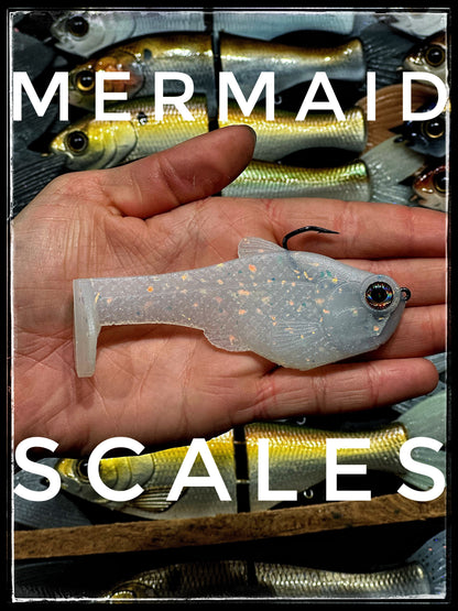 4.5in Nacho boot-tail soft swimbait by Bull Shad Swimbaits, glitter scale, in hand on Tampa Home & Garden Store