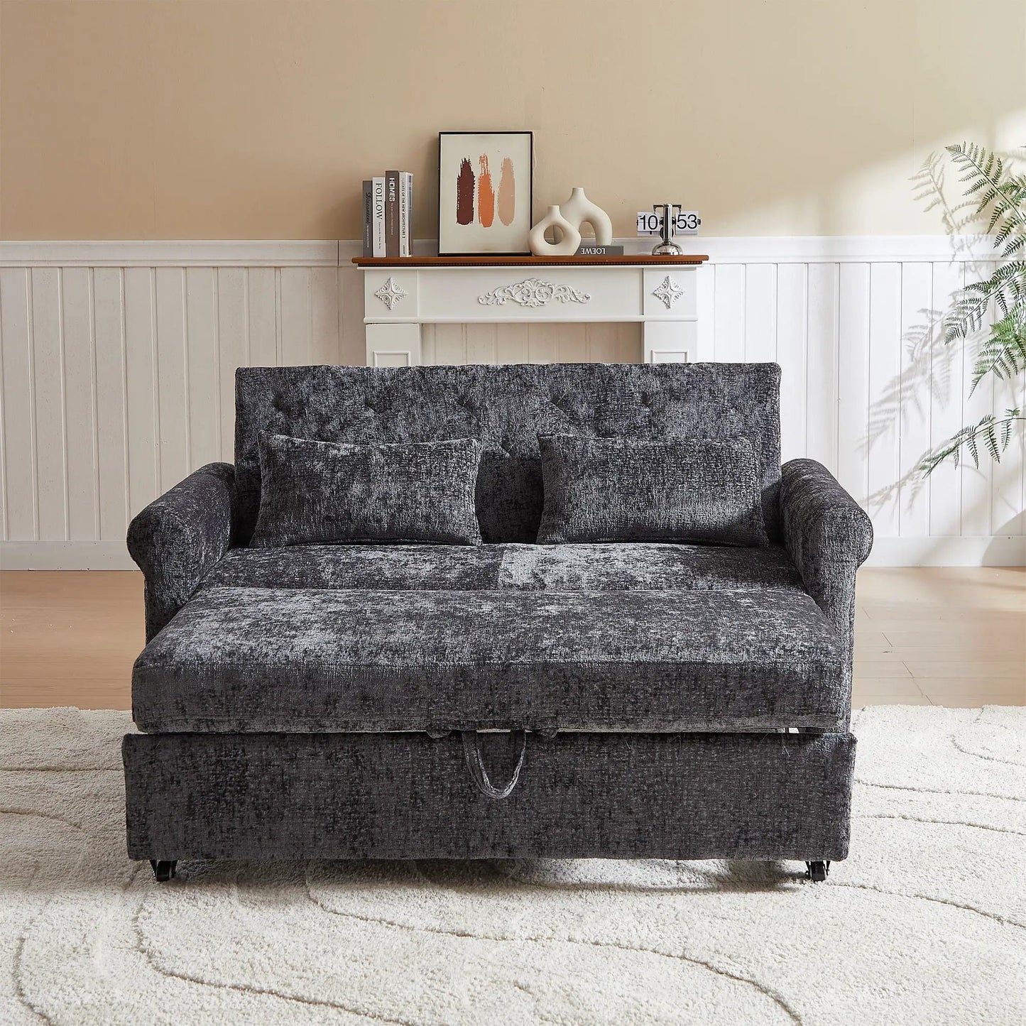 Loveseat sofa bed pull-out with dark charcoal upholstery and two pillows in living room on Tampa Home & Garden Store