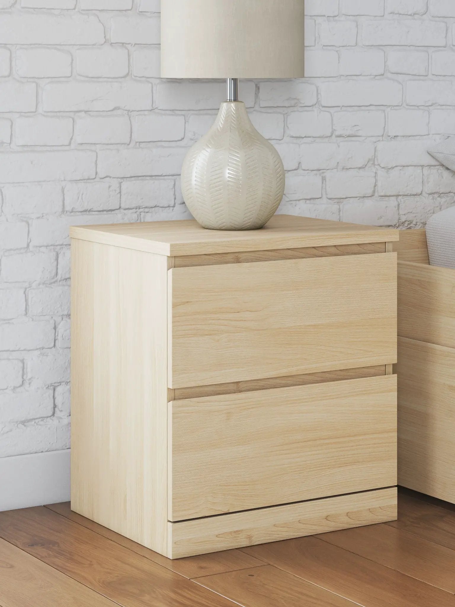Onita two-drawer night stand in natural light wood with a beige ceramic lamp on top on Tampa Home & Garden Store