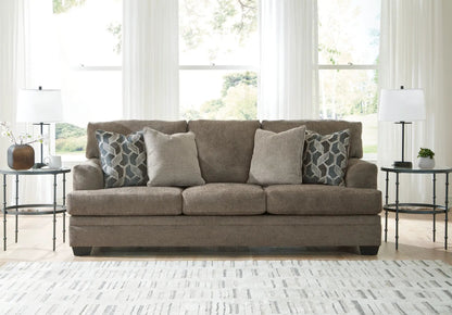 Stonemeade stationary sofa in taupe fabric with two geometric pillows on Tampa Home & Garden Store