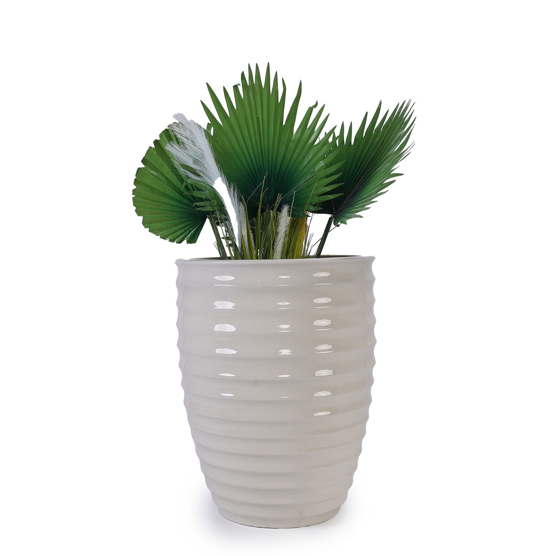 Round ceramic planter with ribbed beige glaze and green fan palm leaves on Tampa Home & Garden Store