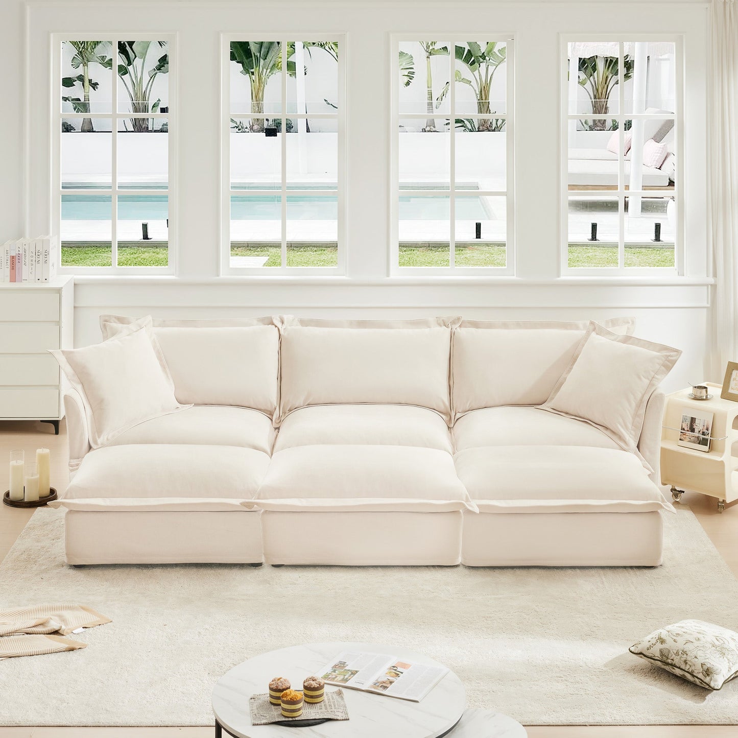 Oversized chenille sofa with 3 cream ottomans in a bright white living room on Tampa Home & Garden Store