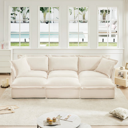 Oversized chenille sofa with 3 cream ottomans in a bright white living room on Tampa Home & Garden Store