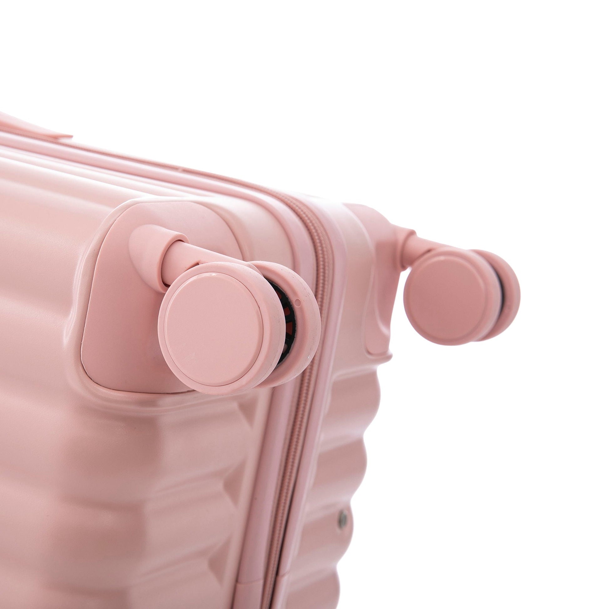 Pink spinner luggage close-up showing wheel assembly and zipper on smooth suitcase on Tampa Home & Garden Store