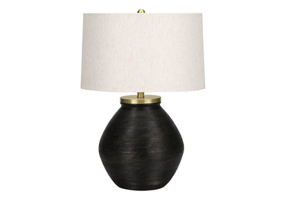 Table lamp with cream fabric shade and black ribbed ceramic base, brass hardware on Tampa Home & Garden Store