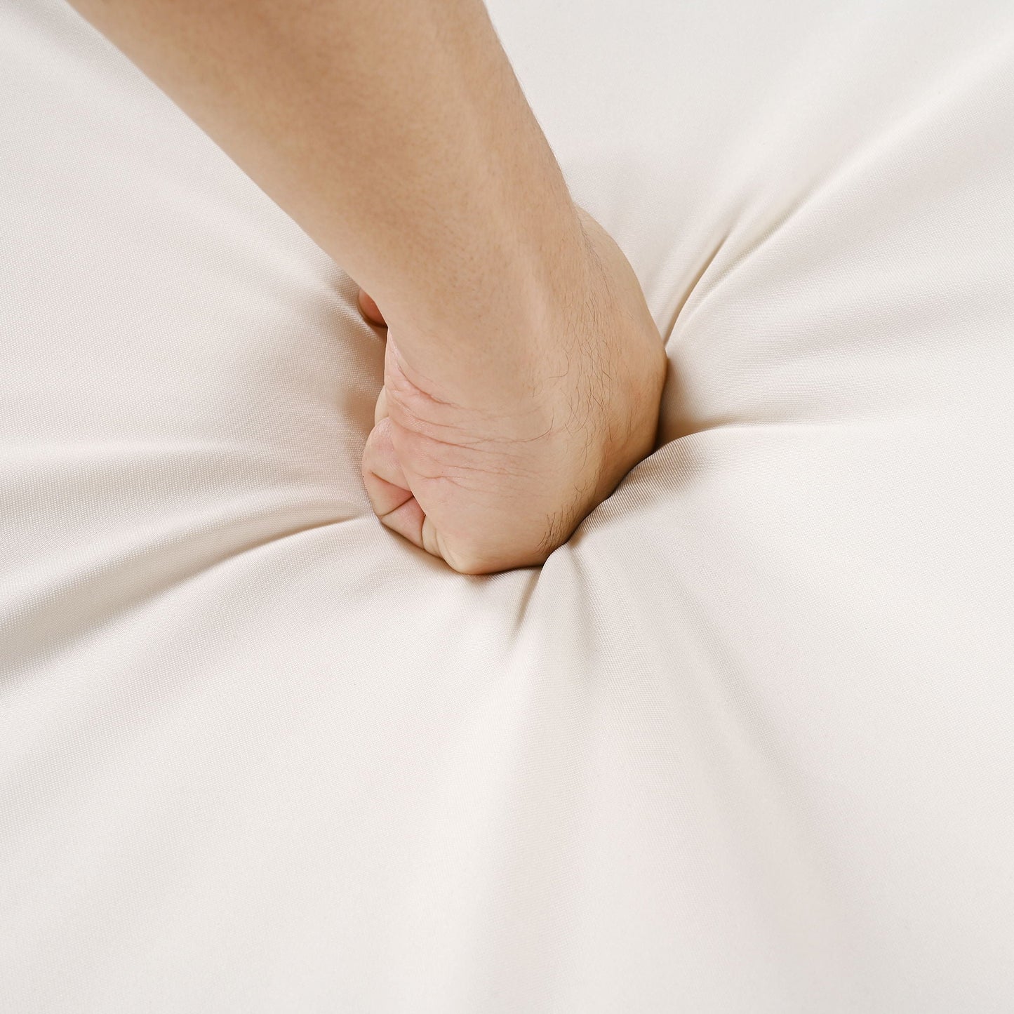 Outdoor lounge chair fabric close-up with a forearm resting on a cream cushion on Tampa Home & Garden Store
