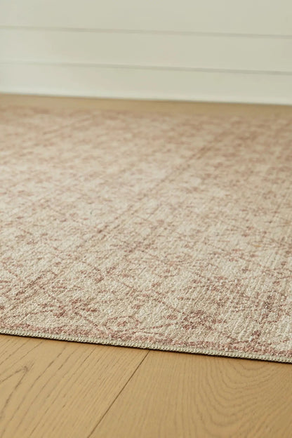 Lyamford rug by Unique Piece Furniture, pink-toned textured pattern on light hardwood floor on Tampa Home & Garden Store