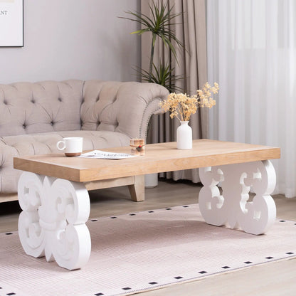 Ornate scroll-base coffee table with natural wood top and white carved base in living room on Tampa Home & Garden Store
