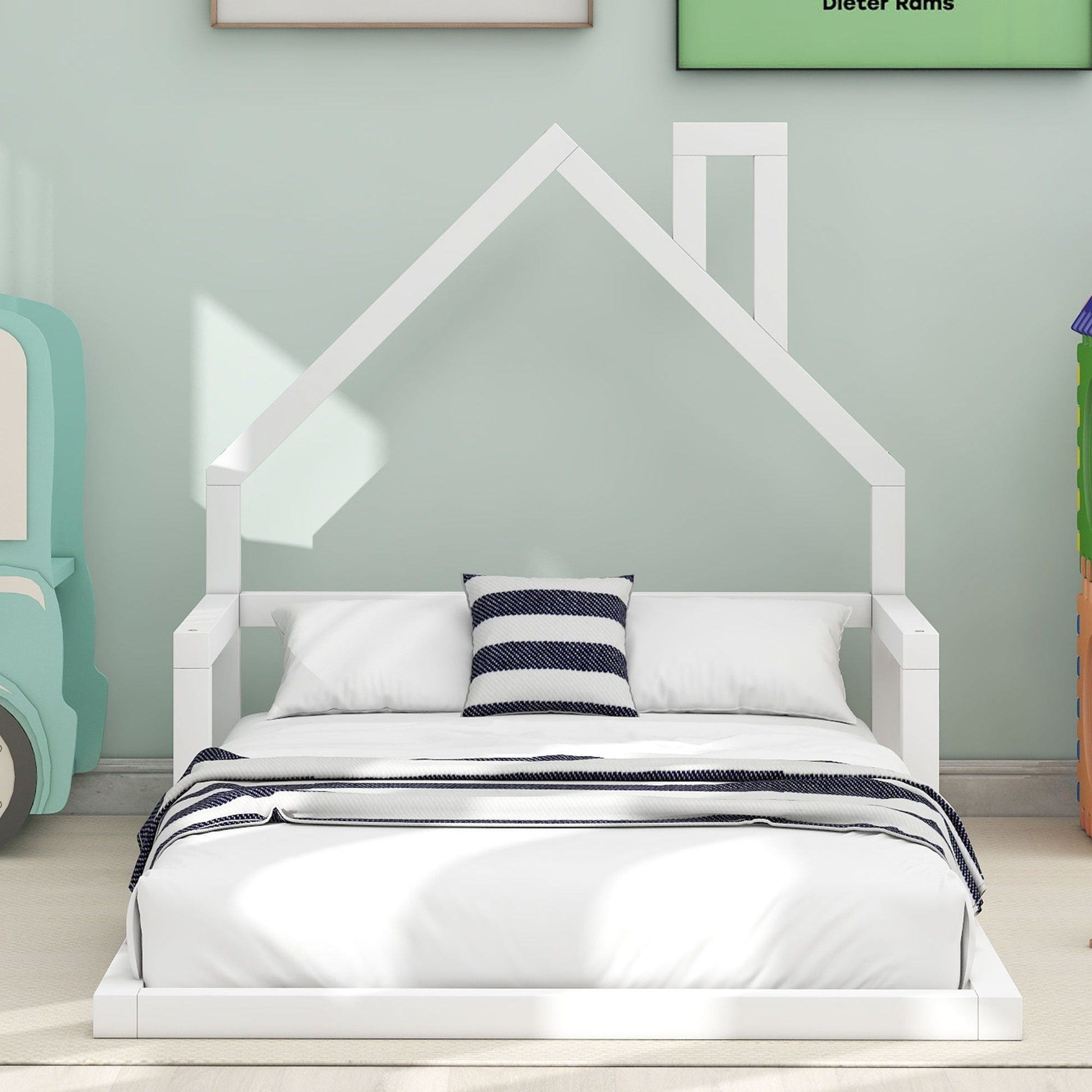 White platform floor bed with a house-shaped headboard, bedding and navy striped pillow on Tampa Home & Garden Store