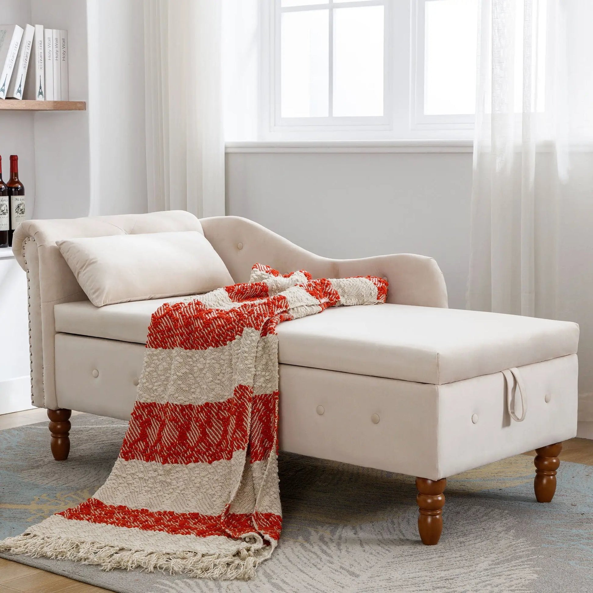 Beige upholstered chaise lounge with storage, rolled arms and nailhead trim in a living space on Tampa Home & Garden Store