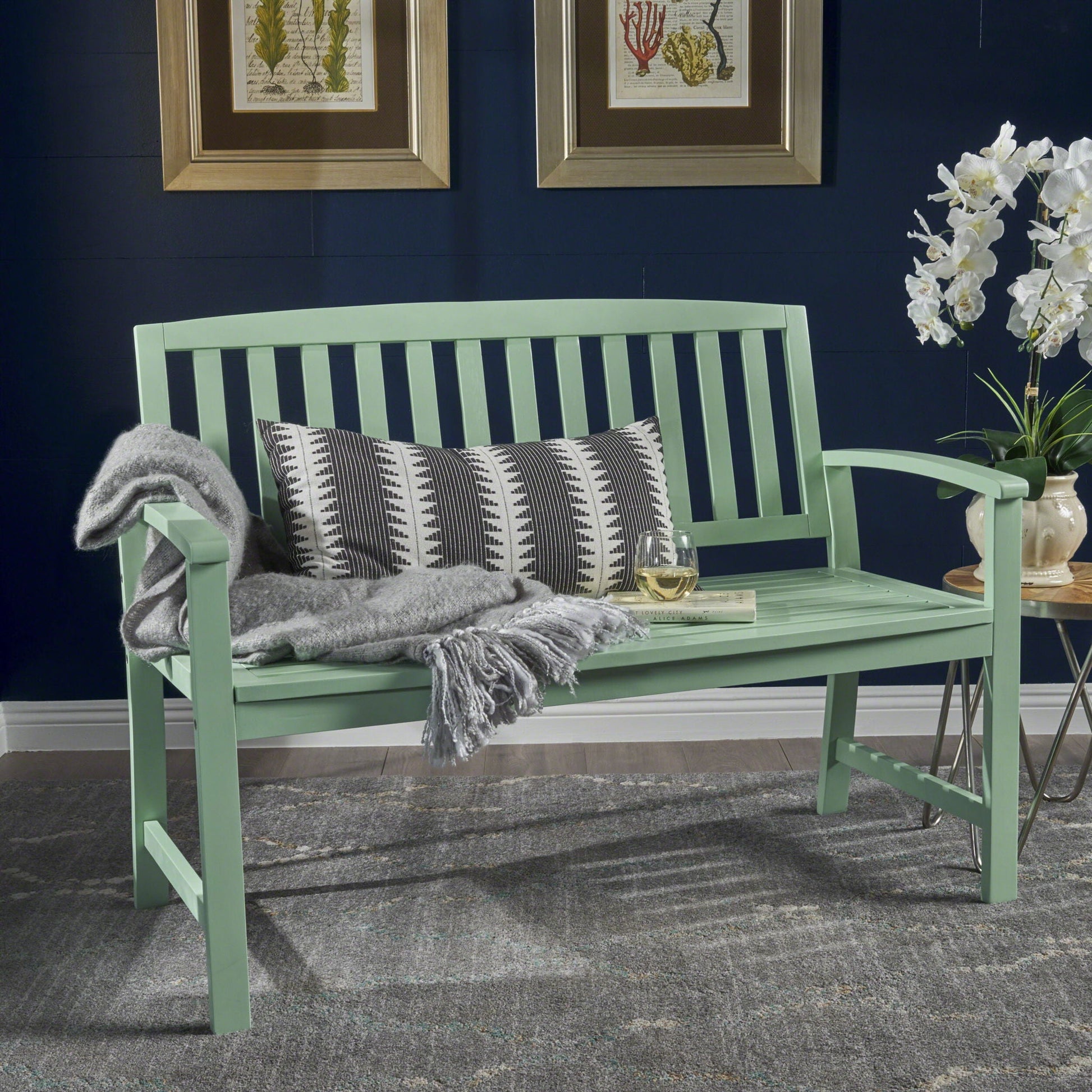 Farmhouse Loja outdoor bench in mint green with slatted back gray throw and geometric pillow on Tampa Home & Garden Store