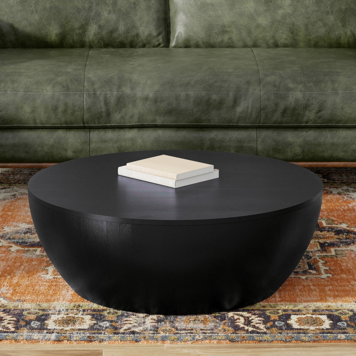 Elmbrook Drum Coffee Table, round black drum table with matte finish; books on top on Tampa Home & Garden Store