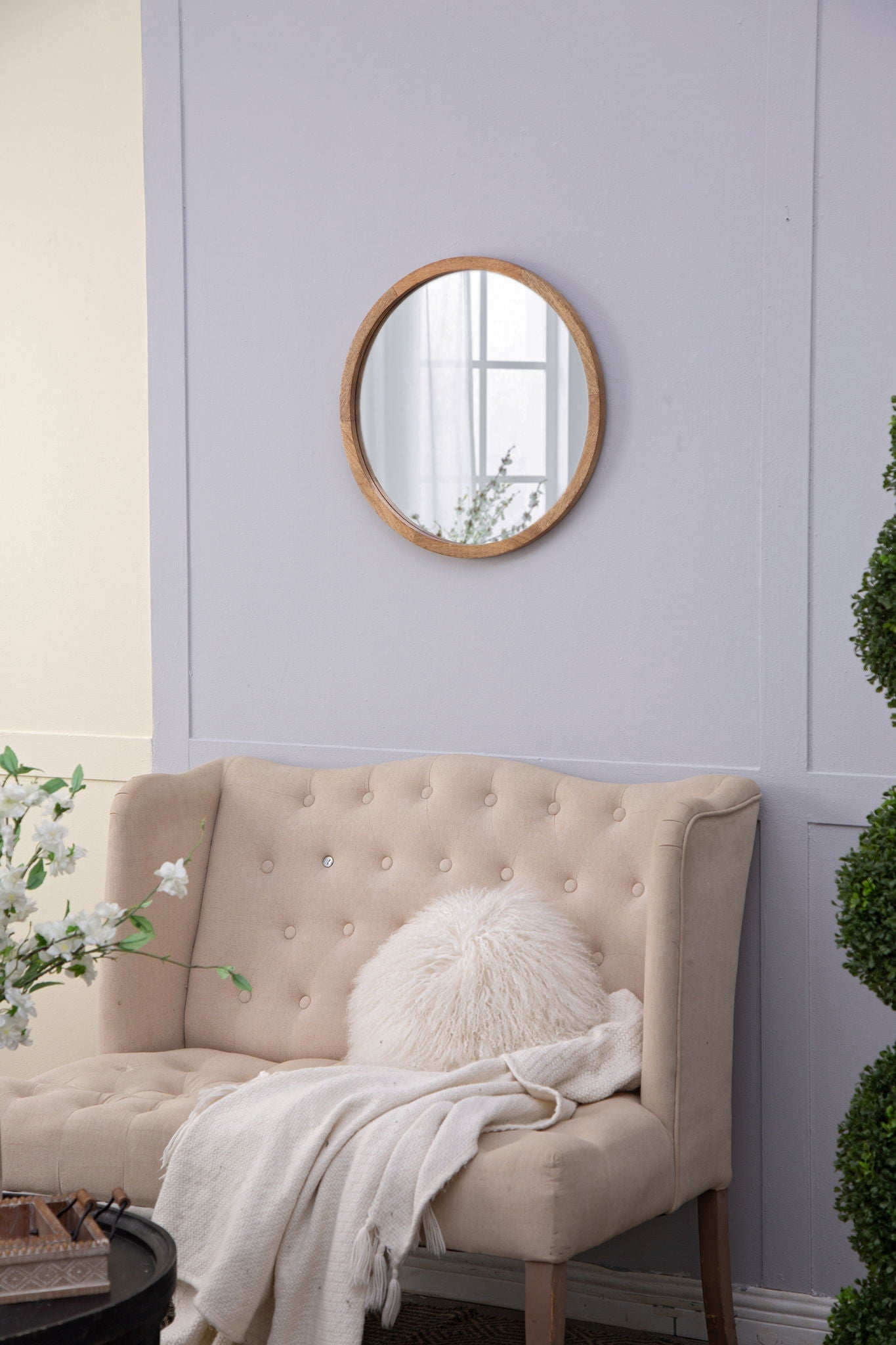 Circle wall mirror with natural wooden frame on lavender living room wall on Tampa Home & Garden Store