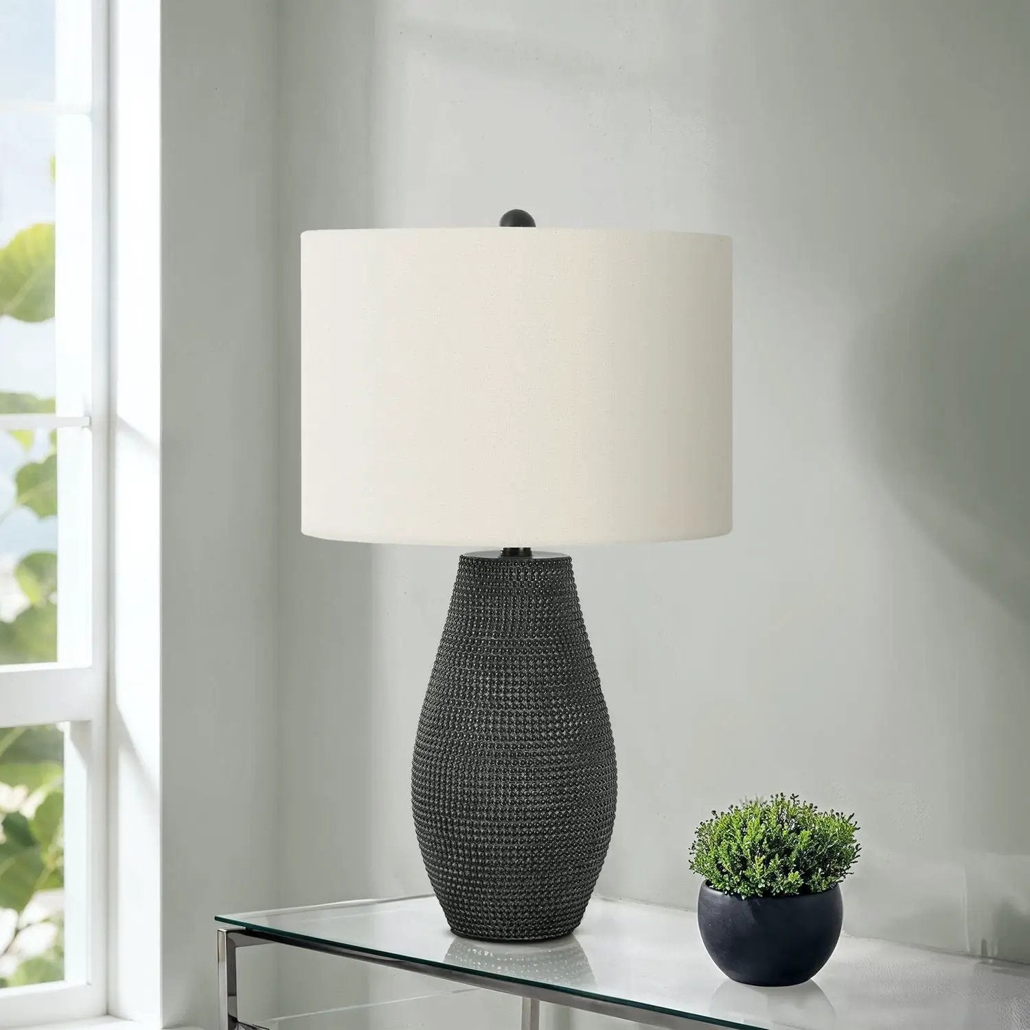 Table lamp with a textured black resin base and beige drum shade by Unique Piece Furniture on Tampa Home & Garden Store
