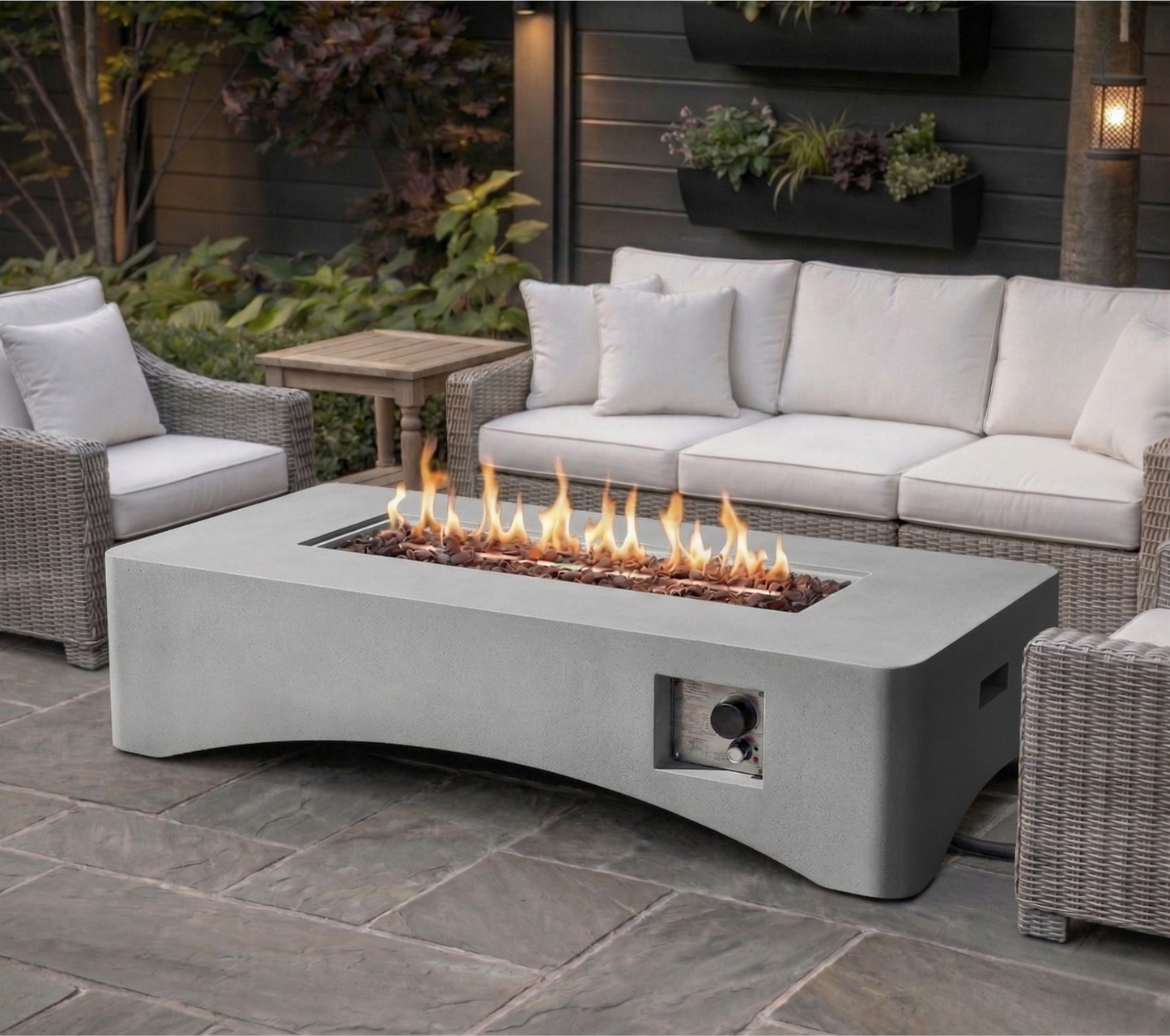 Rectangular concrete propane fire pit table with flames and glass rocks, outdoor wicker seating on Tampa Home & Garden Store