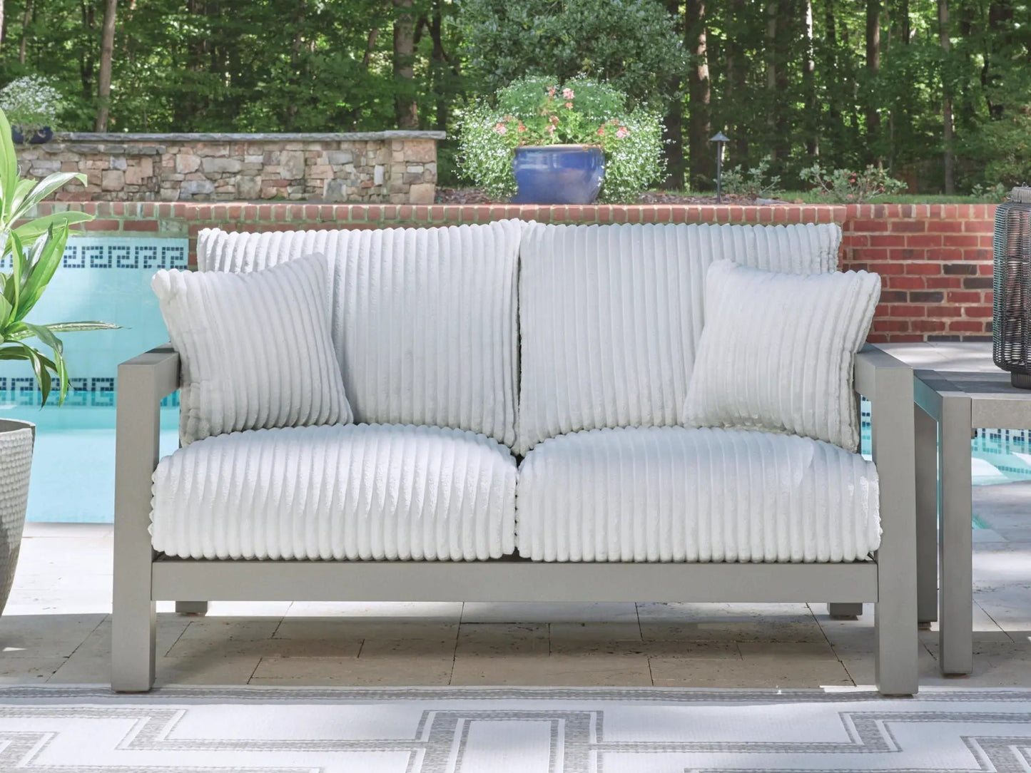 Hurley Park loveseat with gray cushions on a sturdy gray frame on Tampa Home & Garden Store