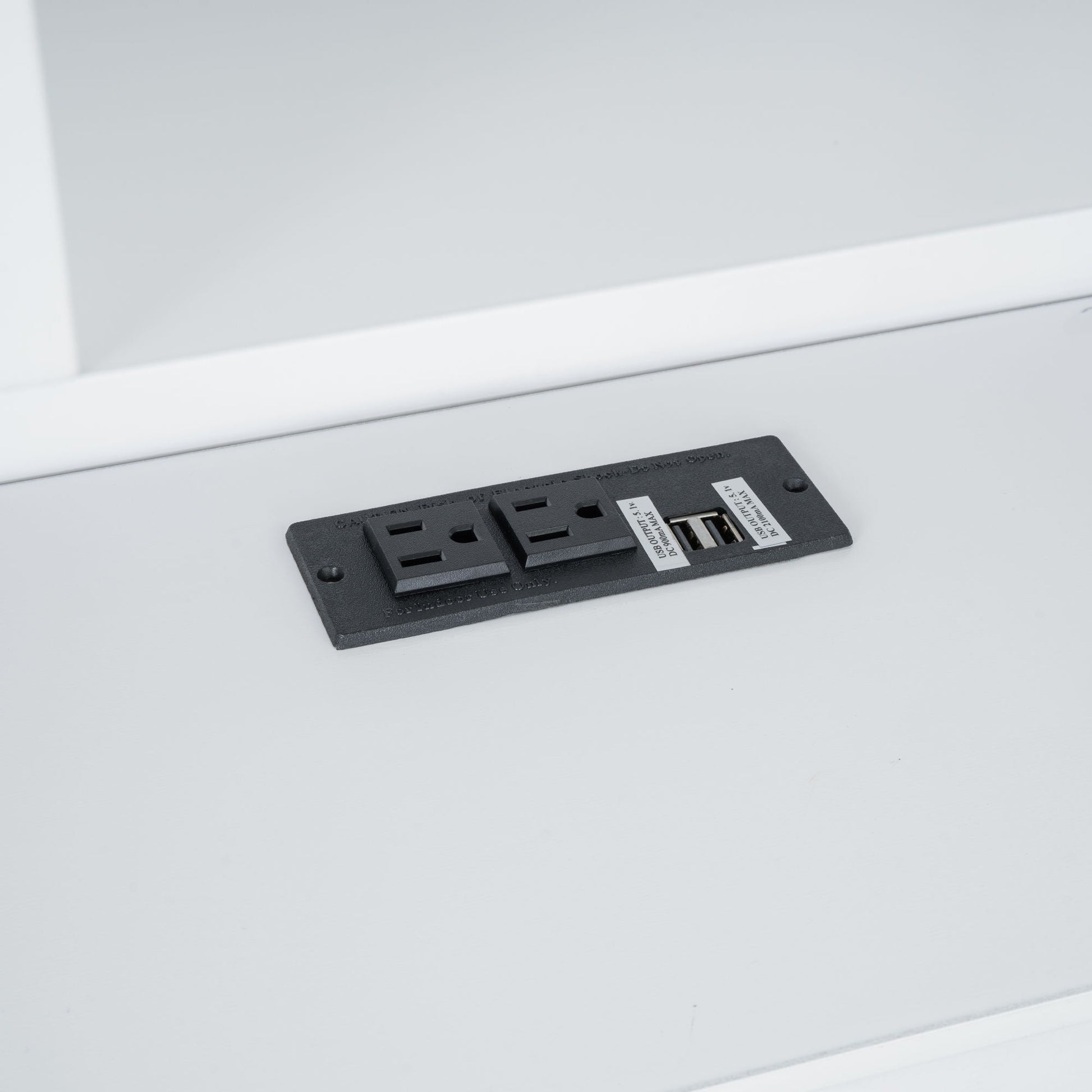 Black platform bed storage panel with USB ports and drawer slots on Tampa Home & Garden Store