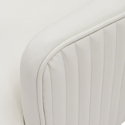 Arm chair close-up in white leather upholstery with curved stitched seams on Tampa Home & Garden Store