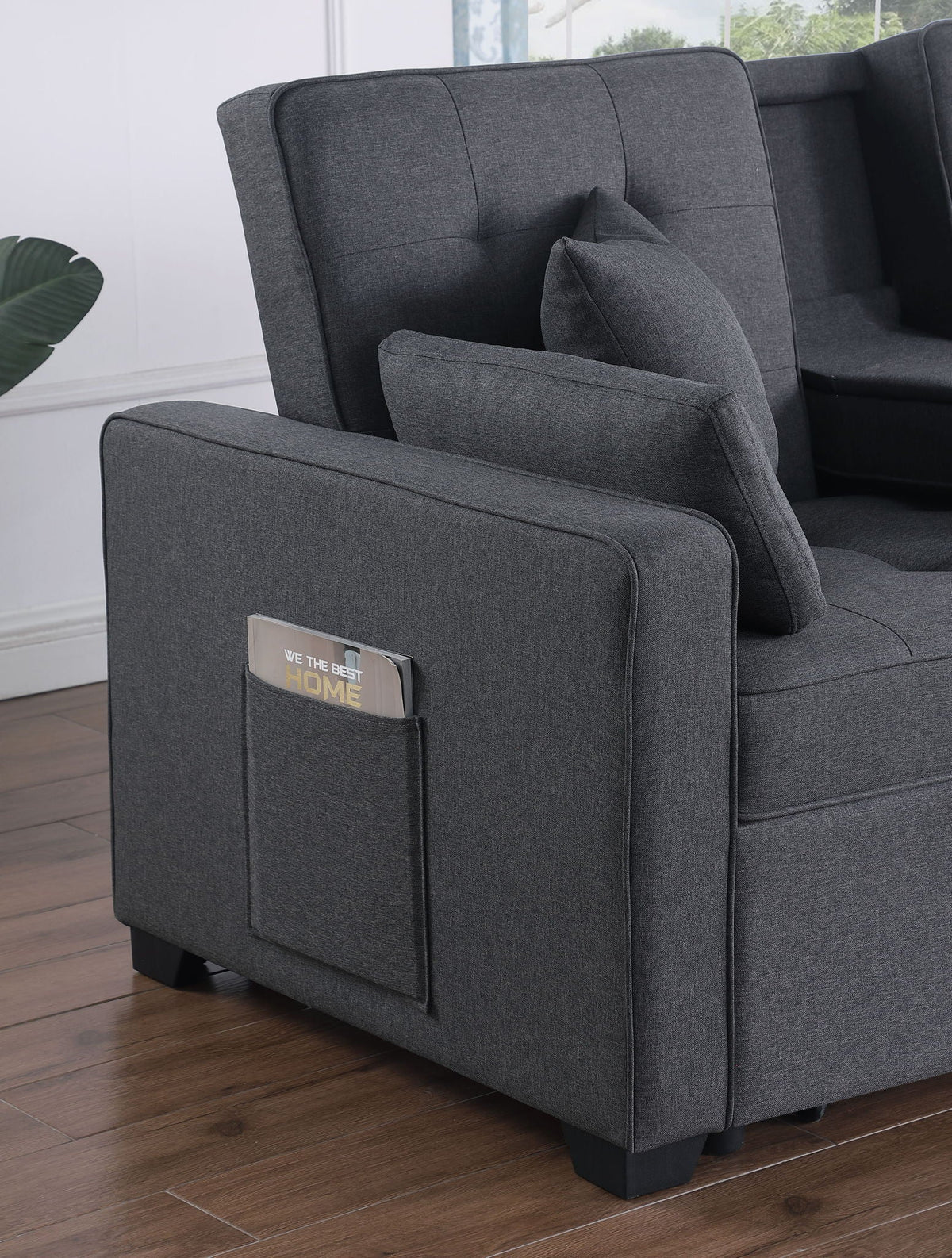 Dark gray sleeper loveseat with tufted back cushions and padded arms, built-in side pocket on Tampa Home & Garden Store