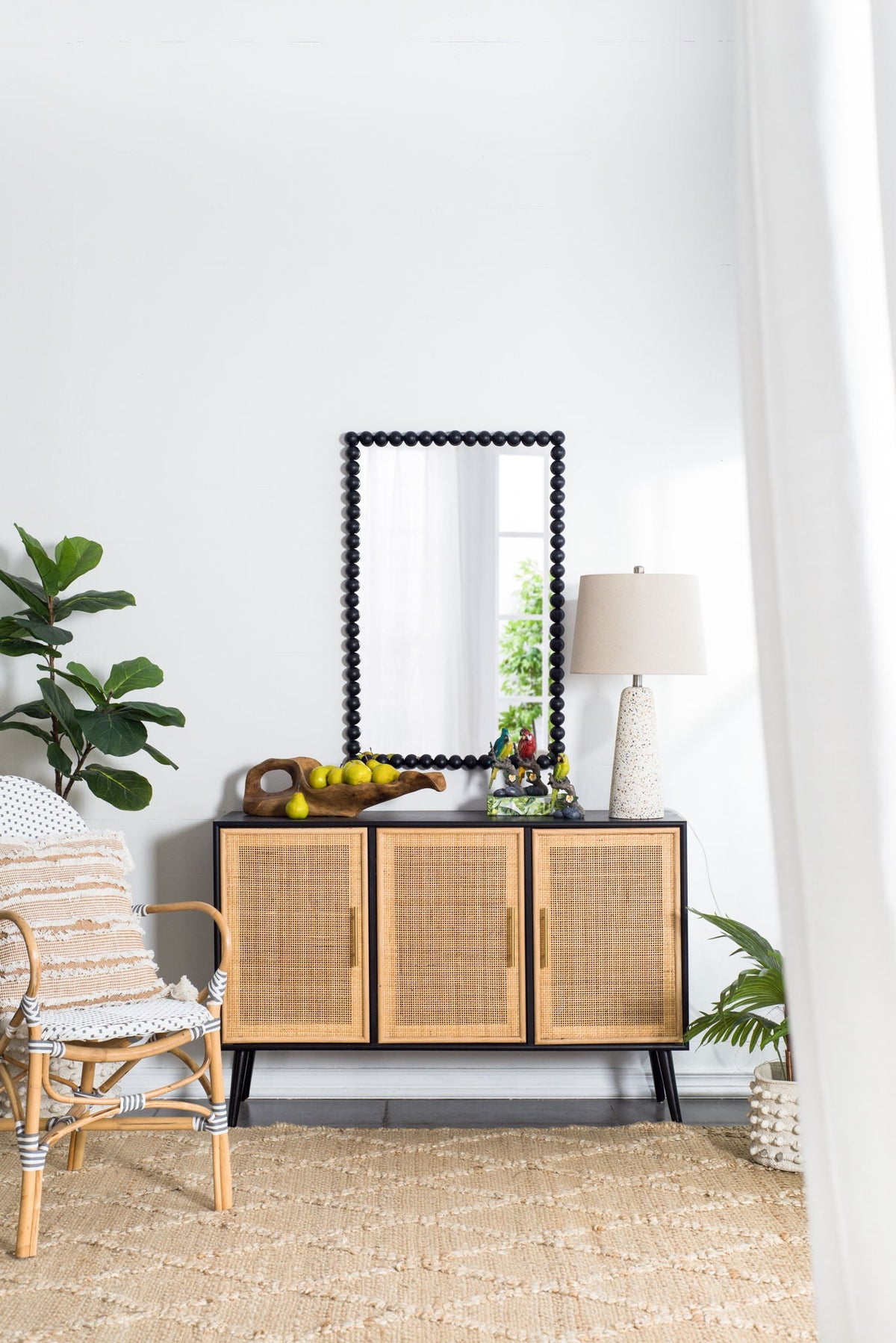 Rectangle black bead-framed wall mirror by HouseOfZazla on a woven cabinet in living room on Tampa Home & Garden Store