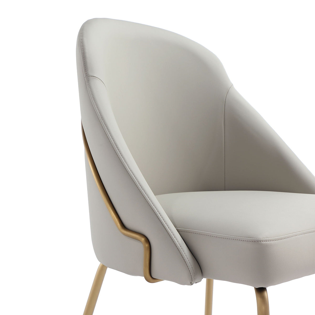 Upholstered dining chair side view in light gray fabric, gold-tone frame, pale wood legs on Tampa Home & Garden Store