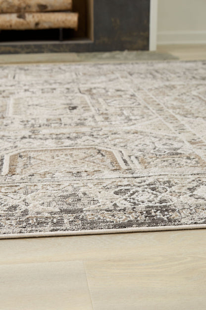 Junley rug, beige and brown ornate area rug with distressed pattern on light floor on Tampa Home & Garden Store