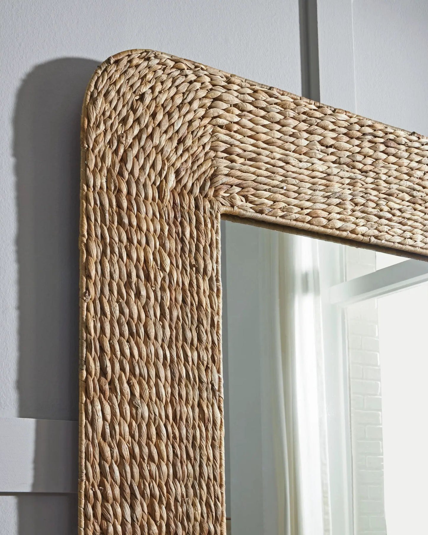 Norigan floor mirror with natural woven rattan frame, close-up of rounded corner on Tampa Home & Garden Store