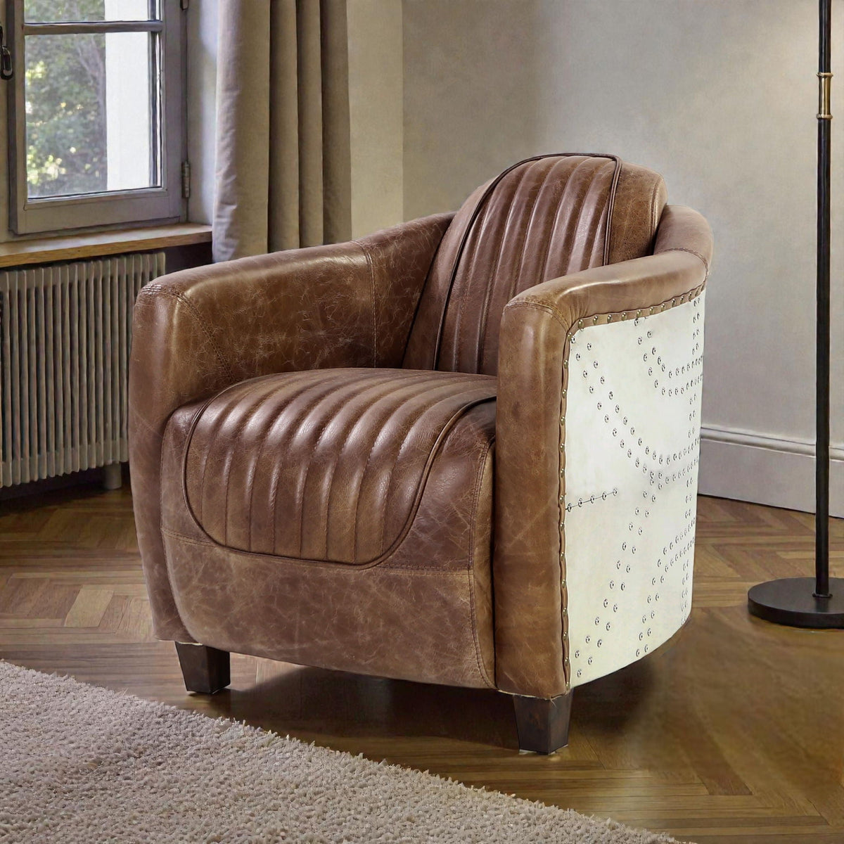 Grain leather arm chair with high back in brown, white studded side panel and dark wooden legs on Tampa Home & Garden Store