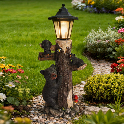 Black bear statue with a welcome sign garden sculpture on a tree-trunk base and solar light on Tampa Home & Garden Store