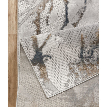 Geometrix Area Rug in Gray with 3D textured geometric pattern layered on wood floor on Tampa Home & Garden Store