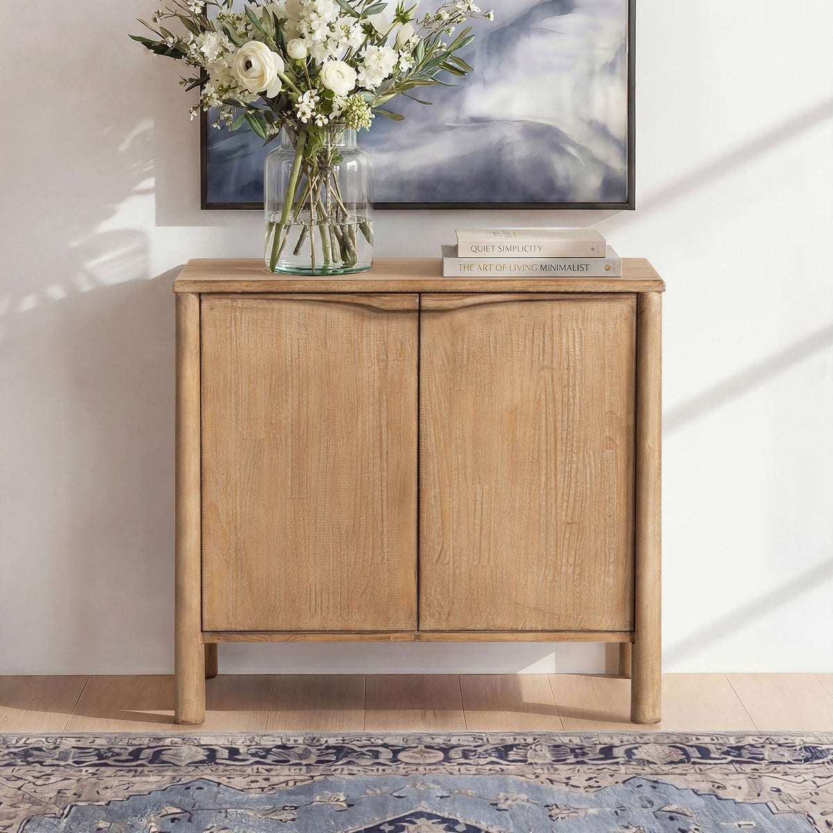 Antique brown 2-door accent cabinet in reclaimed wood finish with a glass vase of white flowers on Tampa Home & Garden Store