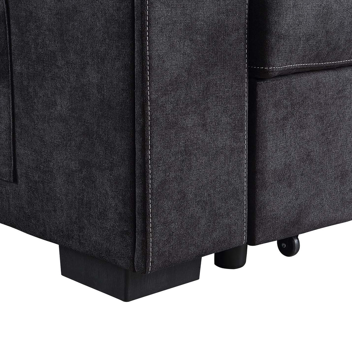 Toby woven fabric sleeper sectional close-up in dark charcoal with white stitching and legs on Tampa Home & Garden Store