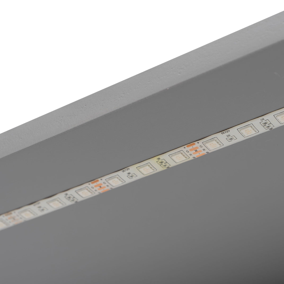 Platform bed frame with LED lighting strip along gray surface, closeup of control panel on Tampa Home & Garden Store