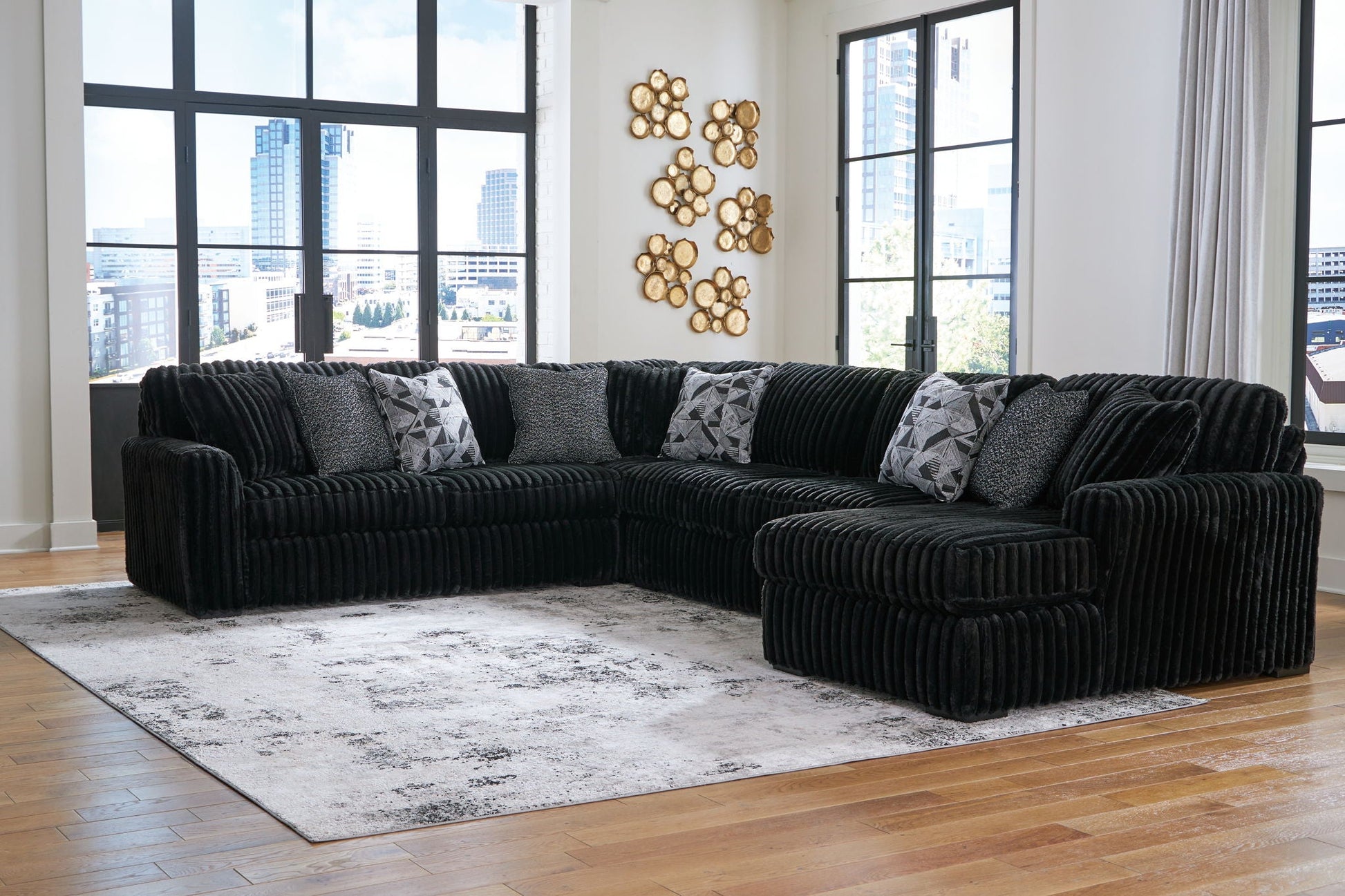 Midnight-Madness 4-piece sectional sofa in black corduroy with grey cushions in living room on Tampa Home & Garden Store