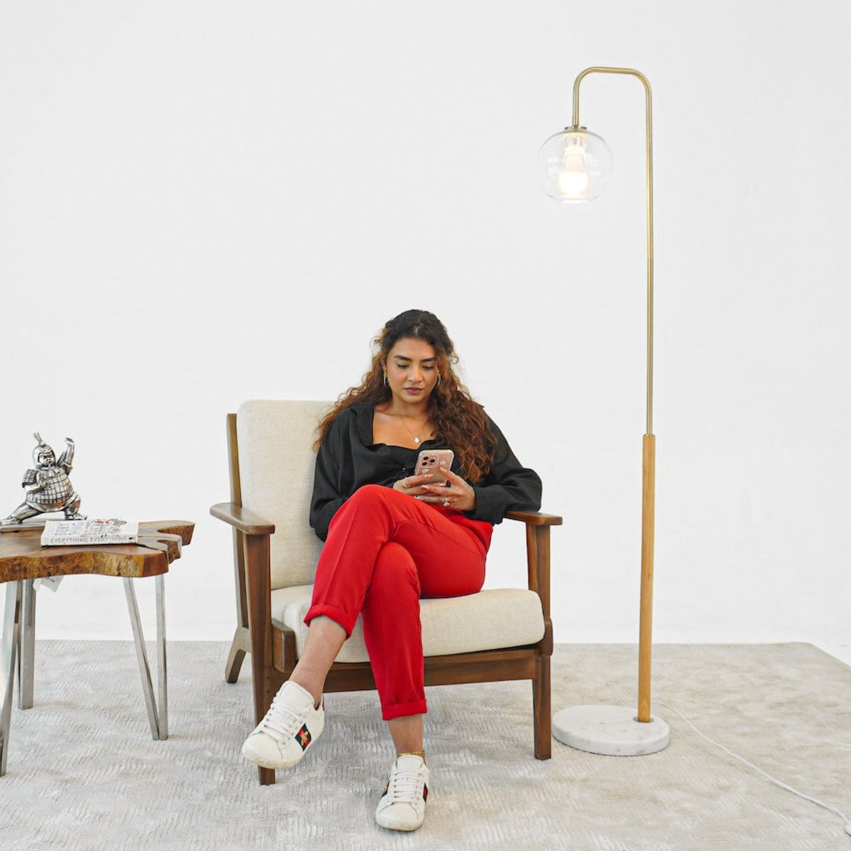 Tall Corner Floor Lamp for Living Room White with glass globe beside a seated woman on Tampa Home & Garden Store