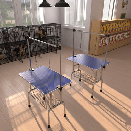 Blue grooming tables for pets with adjustable arms and clamps in a grooming station on Tampa Home & Garden Store