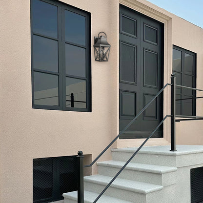 Outdoor wall light by GigaTech, dark gray metal lantern with glass panels on stucco wall on Tampa Home & Garden Store