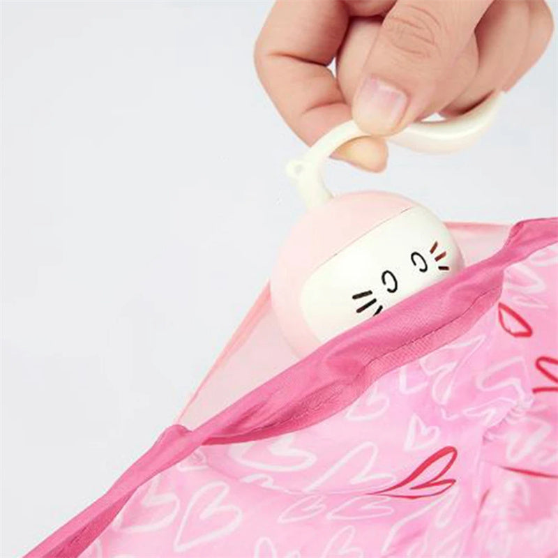 Automatic cat toy ball with a cute cat-face design emerging from a pink heart-pattern bag on Tampa Home & Garden Store