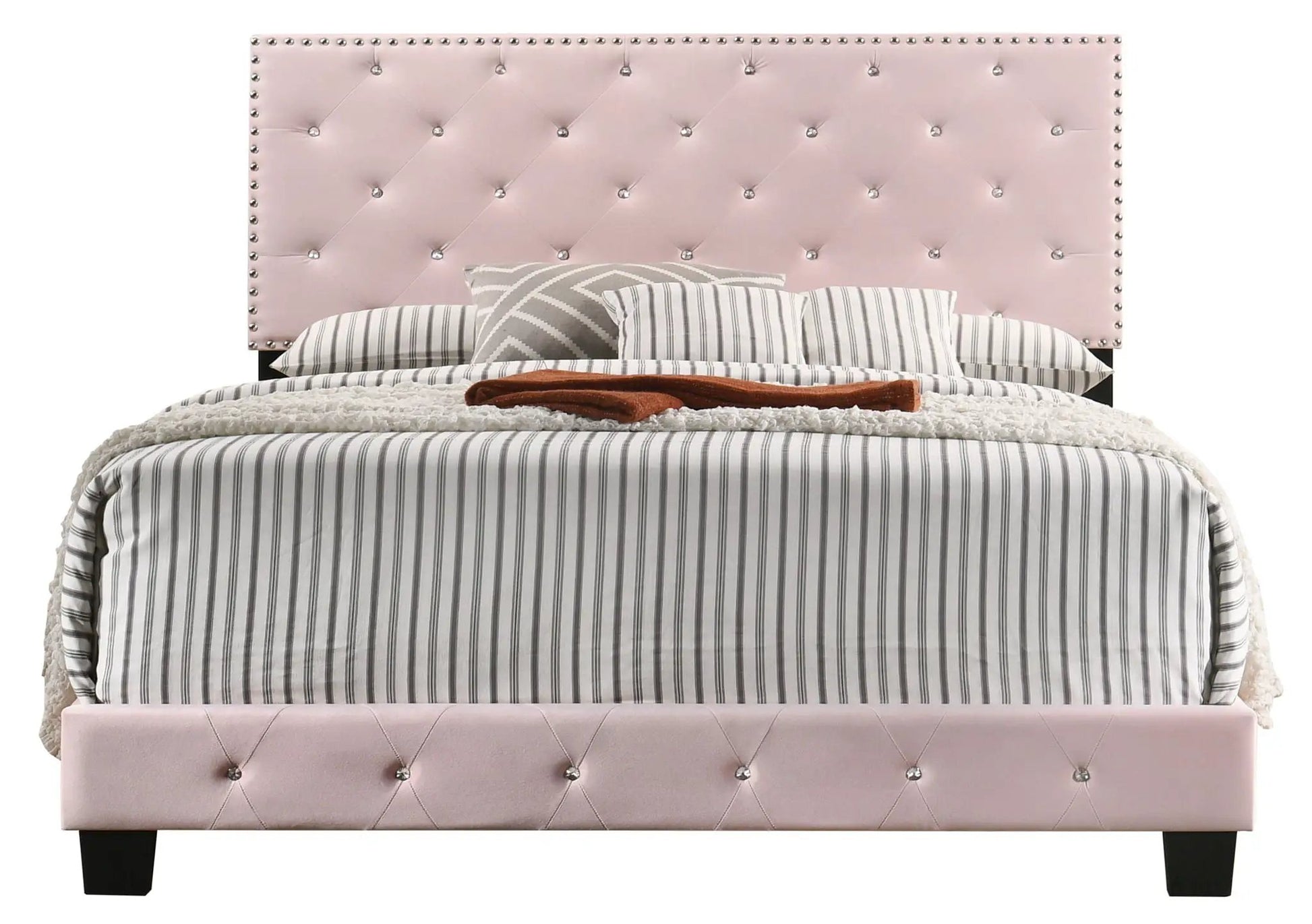Luxurious pink upholstered bed with tufted headboard and crystal buttons, striped bedding on Tampa Home & Garden Store